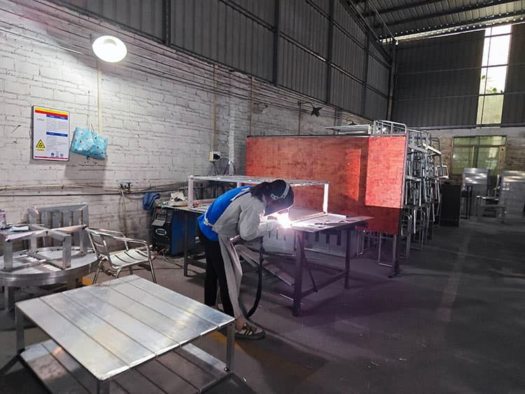 women worker in metal furniture factory